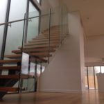 Wooden Staircase with Glass Balustrades — Pool Fencing in Benowa, QLD
