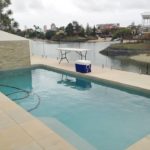 Pool with Glass Balustrades on the Water — Pool Fencing in Benowa, QLD