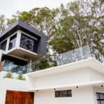 Modern Home with Glass Balustrades on the Balcony — Pool Fencing in Benowa, QLD